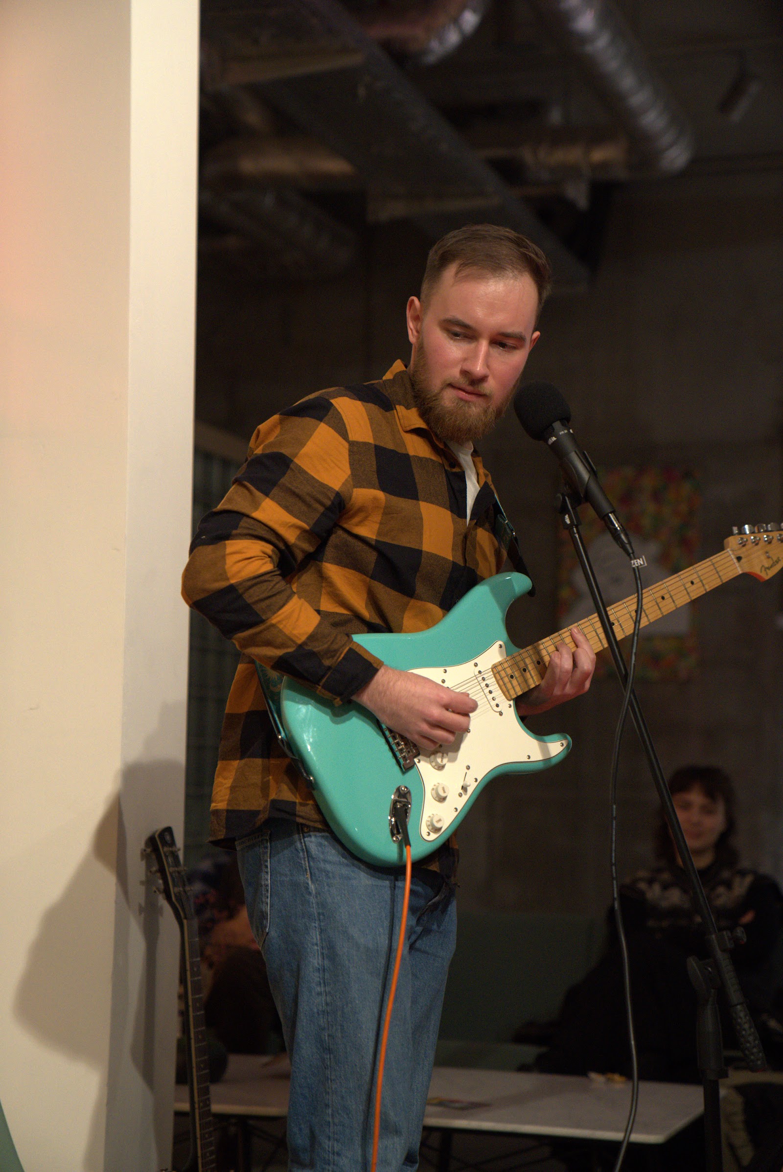 Guitarist at the mic during a jam session